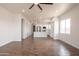 Open-concept living space with wood-look tile flooring and views of the kitchen and dining area at 8226 W Swansea Dr, Arizona City, AZ 85123