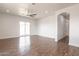 Open living space with wood-look tile flooring and a view of the backyard through sliding glass doors at 8226 W Swansea Dr, Arizona City, AZ 85123