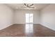 Spacious living room with wood-look tile flooring and sliding glass doors leading to the backyard at 8226 W Swansea Dr, Arizona City, AZ 85123