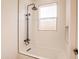Modern shower-tub combo with black fixtures, white subway tile, and a built-in niche at 8226 W Swansea Dr, Arizona City, AZ 85123