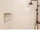 Close-up of the shower showing white subway tile and matte black shower head and fixtures at 8226 W Swansea Dr, Arizona City, AZ 85123