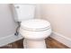 Clean, modern white toilet in a well-lit bathroom with wood-look tile flooring at 8226 W Swansea Dr, Arizona City, AZ 85123