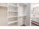 Spacious walk-in closet with built-in shelving and storage, leading to an ensuite bathroom at 8226 W Swansea Dr, Arizona City, AZ 85123