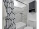 Bathroom featuring marble-look tile surround and a shower/tub combo at 8329 E Keim Dr, Scottsdale, AZ 85250