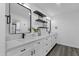 Elegant bathroom with dual sinks, floating shelves, and modern fixtures at 8329 E Keim Dr, Scottsdale, AZ 85250