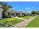 Attractive home exterior featuring manicured lawns and landscaped walkway to the front door at 8329 E Keim Dr, Scottsdale, AZ 85250