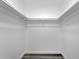 Bright, walk-in closet with built in white shelving for optimal storage at 8329 E Keim Dr, Scottsdale, AZ 85250