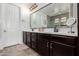Bathroom featuring a dual vanity, stylish lighting, and sleek finishes at 20891 E Cattle Dr, Queen Creek, AZ 85142