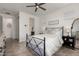 Bright bedroom with a black metal frame bed, neutral walls, tile floor and a ceiling fan at 20891 E Cattle Dr, Queen Creek, AZ 85142