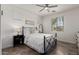 Bright bedroom with a black metal frame bed, neutral walls, tile floor and a ceiling fan at 20891 E Cattle Dr, Queen Creek, AZ 85142