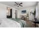 Spacious bedroom with mounted TV, en-suite bathroom, and neutral color palette at 20891 E Cattle Dr, Queen Creek, AZ 85142