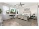 Bright bedroom featuring a ceiling fan, neutral decor, and plenty of natural light at 20891 E Cattle Dr, Queen Creek, AZ 85142