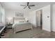 Comfortable bedroom with ceiling fan, en-suite bathroom and neutral color palette at 20891 E Cattle Dr, Queen Creek, AZ 85142