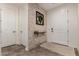 Inviting foyer with neutral tile floors, accent wall, and a decorative shelf at 20891 E Cattle Dr, Queen Creek, AZ 85142