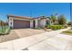 Lovely single-story home with desert landscaping, a tile roof, and a paver driveway at 20891 E Cattle Dr, Queen Creek, AZ 85142