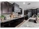 Modern kitchen featuring granite countertops, stainless steel appliances, and dark cabinetry at 20891 E Cattle Dr, Queen Creek, AZ 85142