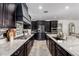 Well-appointed kitchen featuring dark cabinetry, granite countertops, and stainless steel appliances at 20891 E Cattle Dr, Queen Creek, AZ 85142