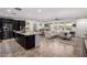 Spacious living space with an open kitchen, dining area, and a comfortable living room at 20891 E Cattle Dr, Queen Creek, AZ 85142