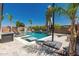 Luxurious pool with water feature and tanning ledge, complete with lounge chairs and an umbrella, perfect for relaxation at 20891 E Cattle Dr, Queen Creek, AZ 85142