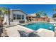 Wonderful backyard pool with tanning ledge and mature trees provides a relaxing outdoor space near the back porch at 20891 E Cattle Dr, Queen Creek, AZ 85142