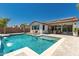 Sparkling pool with tanning ledge, solar panels, and covered patio create an ideal outdoor oasis at 20891 E Cattle Dr, Queen Creek, AZ 85142