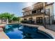 Backyard with pool, second story deck and covered patio creates an inviting outdoor living space at 401 E Barbara Dr, Tempe, AZ 85288