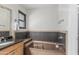 Bathroom featuring a soaking tub with modern fixtures and a neutral color palette at 401 E Barbara Dr, Tempe, AZ 85288