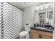 Bathroom featuring a shower/tub with chevron patterned shower curtain and modern vanity at 401 E Barbara Dr, Tempe, AZ 85288