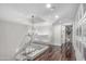 Bright hallway features wood floors, white walls, decorative lighting and gallery wall display at 401 E Barbara Dr, Tempe, AZ 85288