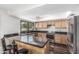 Charming kitchen featuring dark countertops, wood cabinets, and stainless steel appliances at 401 E Barbara Dr, Tempe, AZ 85288