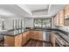 Kitchen showcasing wood cabinets, dark countertops and backsplash, and stainless steel appliances at 401 E Barbara Dr, Tempe, AZ 85288