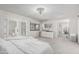 Spacious main bedroom with natural light, plush carpeting, and French doors to the backyard at 401 E Barbara Dr, Tempe, AZ 85288