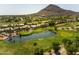 Scenic aerial view capturing the golf course, pond, and community set against a mountain backdrop at 4525 N 66Th St # 112, Scottsdale, AZ 85251