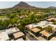 This aerial view shows the desert-style community layout, mature landscaping, and mountain views at 4525 N 66Th St # 112, Scottsdale, AZ 85251