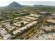 Expansive aerial view showcases a residential neighborhood with lush greenery and mountain backdrop at 4525 N 66Th St # 112, Scottsdale, AZ 85251