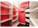 Walk-in closet with custom shelves and black and white hot water tank at 4525 N 66Th St # 112, Scottsdale, AZ 85251