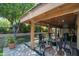 Inviting covered patio features an outdoor dining set and a lush backyard view at 4525 N 66Th St # 112, Scottsdale, AZ 85251