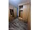 A bedroom with wood-style walls, a closet with drawers and a mirror at 530 S Alma School Rd # 50, Mesa, AZ 85210