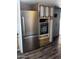 The kitchen contains a stainless steel refrigerator and oven, as well as cabinets and drawers at 530 S Alma School Rd # 50, Mesa, AZ 85210