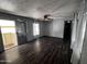 Inviting living room with wood-look flooring, ceiling fan, and sliding glass door at 530 S Alma School Rd # 50, Mesa, AZ 85210