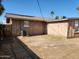 A view of the back of the home showing the backyard, landscaping and air conditioning unit at 6017 W Colter St, Glendale, AZ 85301