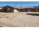 Single story home showcasing its desert landscaping, a long driveway and front facade at 6017 W Colter St, Glendale, AZ 85301
