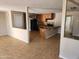 An open concept kitchen shows its tiled flooring, wooden cabinets and granite countertops at 6017 W Colter St, Glendale, AZ 85301
