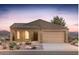 Charming single-story home with a neutral color scheme, arched entryway, desert landscaping, and attached two-car garage at 13524 W Copperleaf Ln, Peoria, AZ 85383