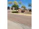 Community entrance to Hidden Hills featuring stone pillars and signage at 17929 W Estes Way, Goodyear, AZ 85338