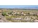 Scenic aerial view of a desert neighborhood with charming homes and stunning mountain views in the distance at 17929 W Estes Way, Goodyear, AZ 85338