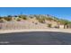 Street view of land in community with desert landscape and utilities at 17929 W Estes Way, Goodyear, AZ 85338