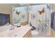 Well-lit bathroom with white sink, vanity, butterfly shower curtain, and neutral-colored walls at 5640 E Bell Rd # 1099, Scottsdale, AZ 85254