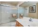 Clean bathroom with white tile surround, glass shower doors, updated vanity, and modern fixtures at 5640 E Bell Rd # 1099, Scottsdale, AZ 85254