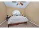 Cozy bedroom featuring a ceiling fan, an arched window, and warm, neutral-toned walls at 5640 E Bell Rd # 1099, Scottsdale, AZ 85254